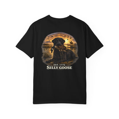 Black t-shirt with a graphic of a dog and sunset scene on the back, featuring the text 'Est. 1776 Silly Goose'.
