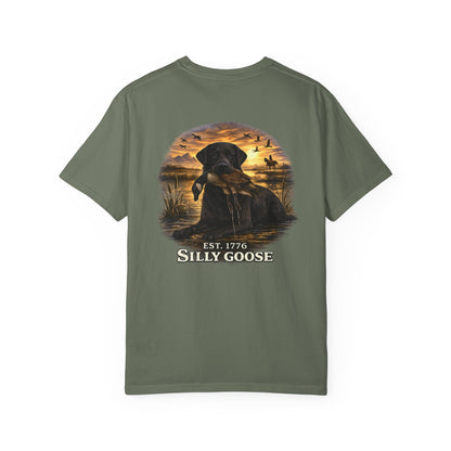 Green t-shirt with a graphic of a dog and sunset scene on the back, featuring the text 'Silly Goose'.