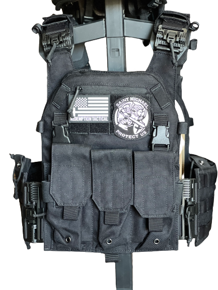 Black tactical vest with various pouches and patches on a white background